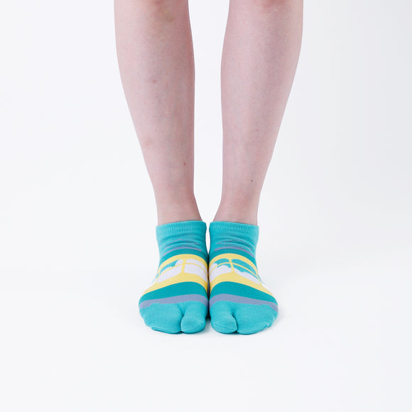 Person wearing short green Tabi Socks " Densha ", front view