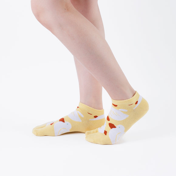 Person wearing short yellow Tabi Socks " Hato ", right side view