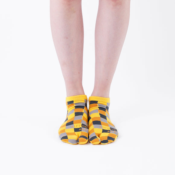 Person wearing short yellow Tabi Socks " Chigiri-e ", front view